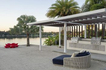 a patio with a couch and a table next to a river at Lakeside Villas, Orlando, FL